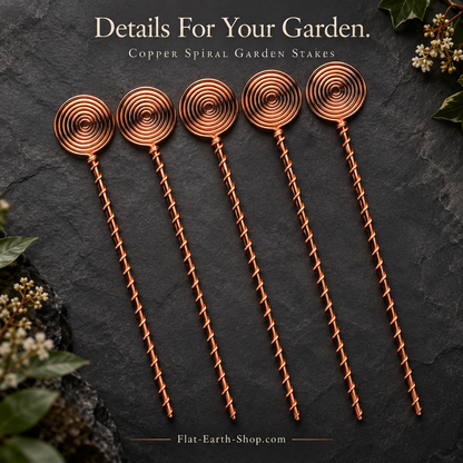Five copper-colored garden stakes with round spiral tops and wire-wrapped stems arranged on dark slate.