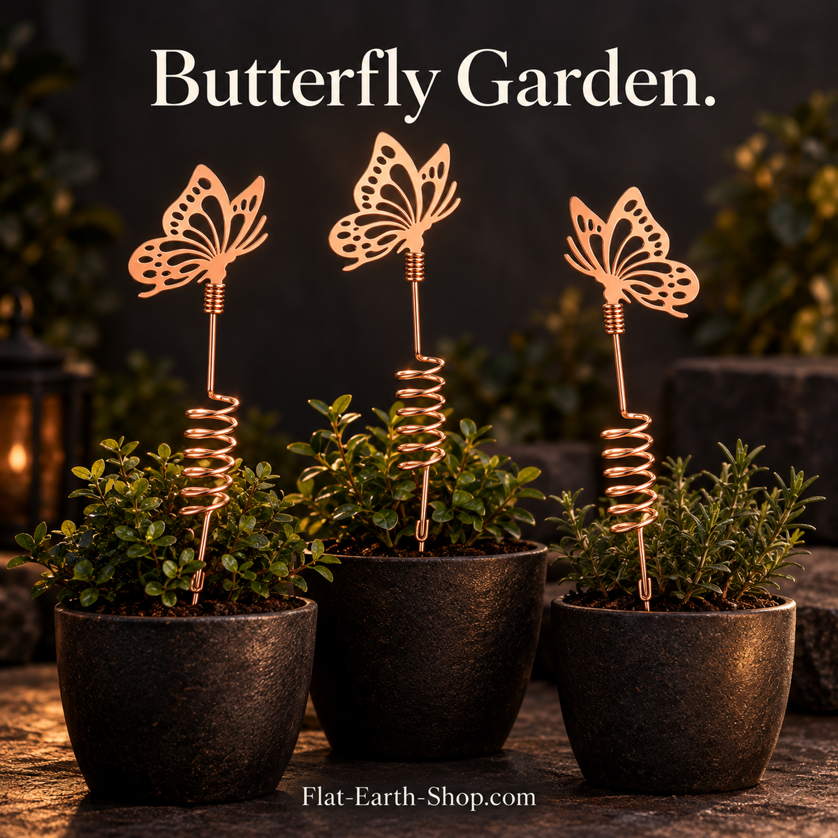 Three copper butterfly garden stakes in a dark setting