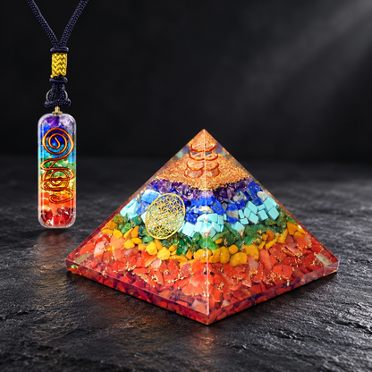 Seven-Chakra Orgonite Pyramid & Pendant — Spectrum of Intention on a dark slate tabletop