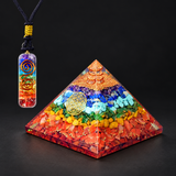 Seven-Chakra Orgonite Pyramid & Pendant — Spectrum of Intention on a dark charcoal studio background