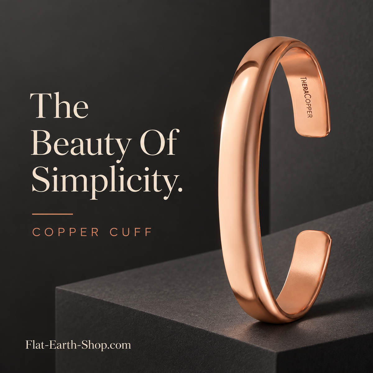 Polished copper-colored open cuff standing upright on a dark geometric pedestal.