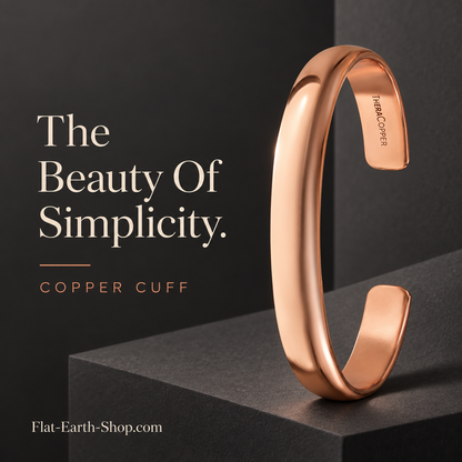 Polished copper-colored open cuff standing upright on a dark geometric pedestal.