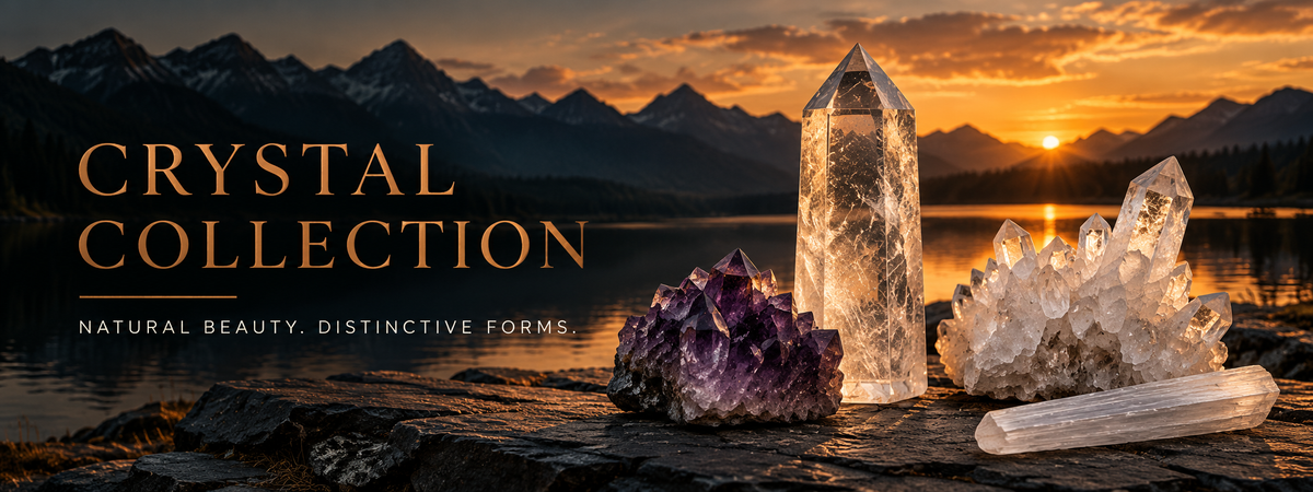 Crystal Collection — Natural beauty. Distinctive forms. Clear quartz points and cluster, amethyst and selenite on slate at sunset.