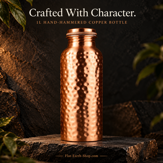 Copper Water Bottle — 1L Hand-Hammered Design — main product view on dark slate with warm copper lighting.
