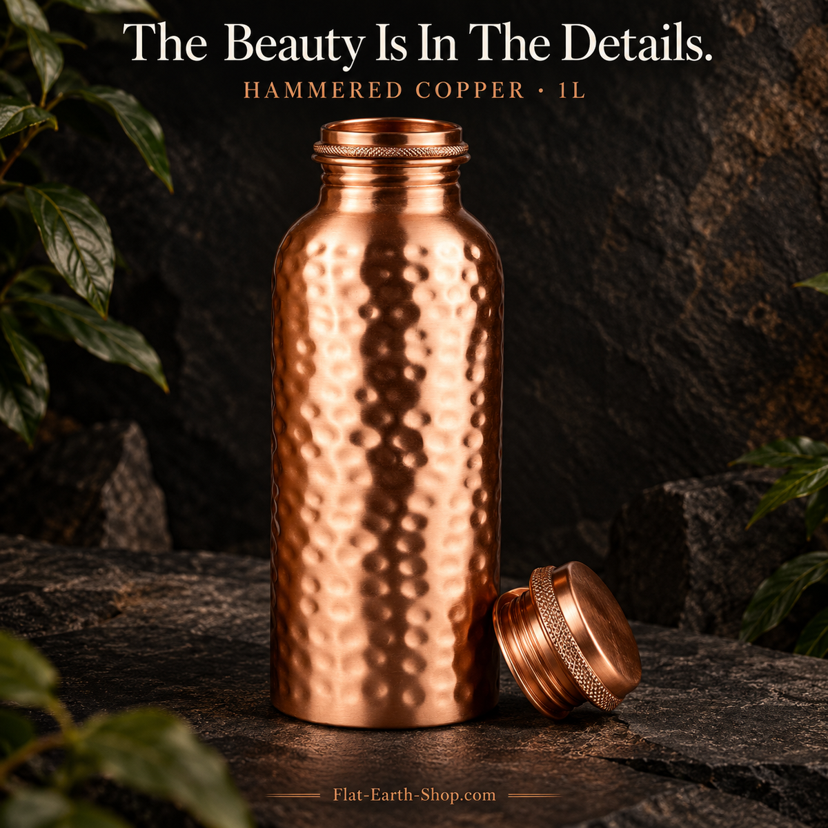 Copper Water Bottle — 1L Hand-Hammered Design — detail product view on dark slate with warm copper lighting.