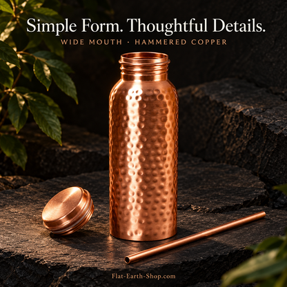 Copper Water Bottle — 34oz Wide Mouth with Straw — detail product view on dark slate with warm copper lighting.