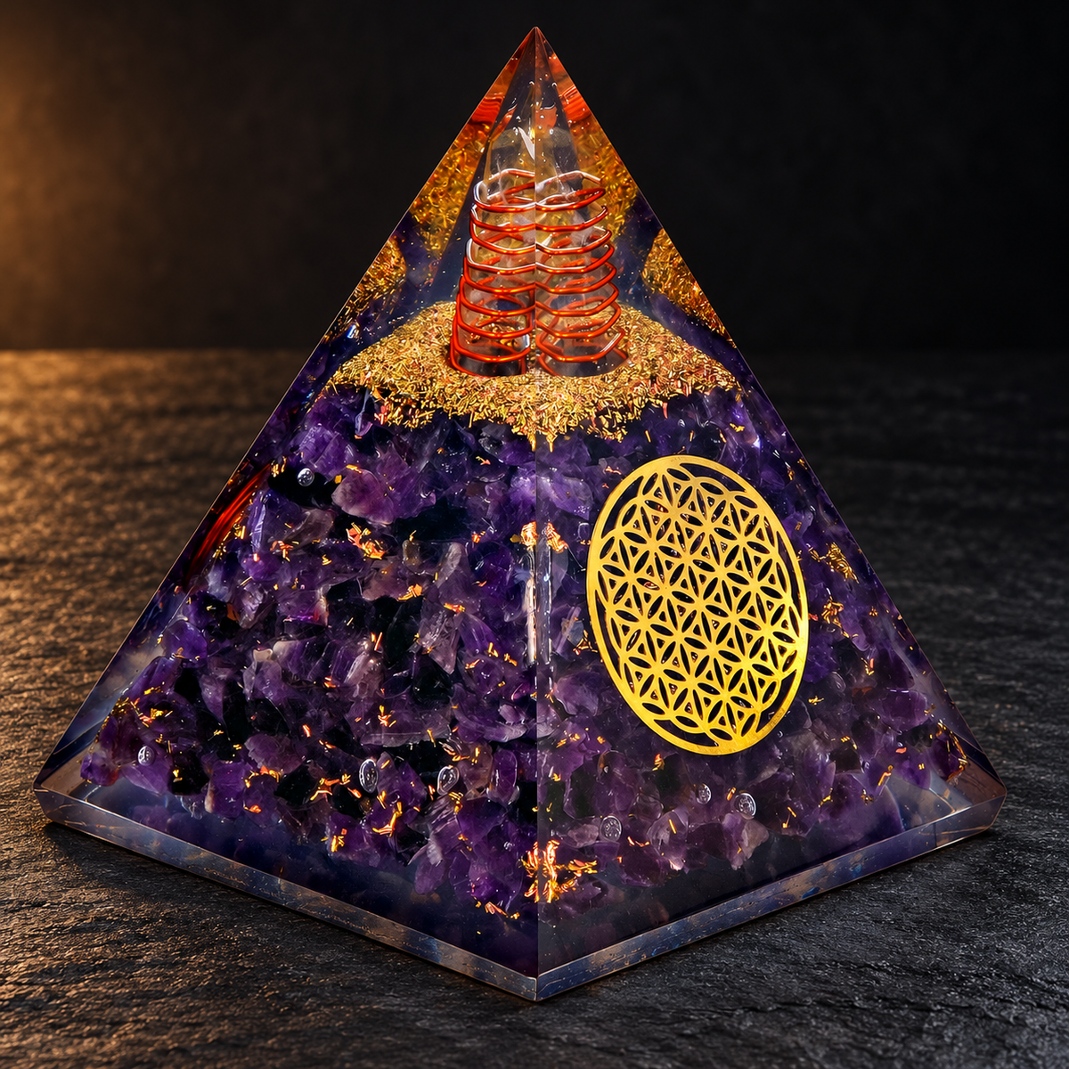 Amethyst Orgonite Pyramid — Flower of Life on a dark slate tabletop