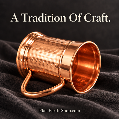 Hammered copper tankard with curved handle in a dark studio scene