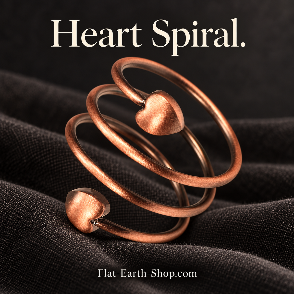 heart spiral copper ring design in a dark studio setting
