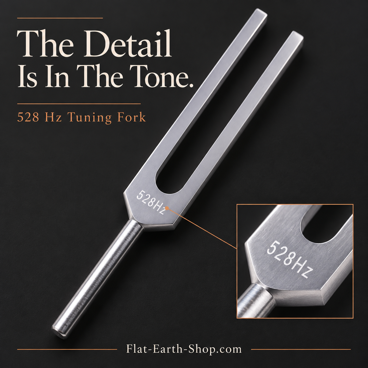 Silver-colored tuning fork angled on a dark background, with an enlarged inset showing its 528 Hz marking.
