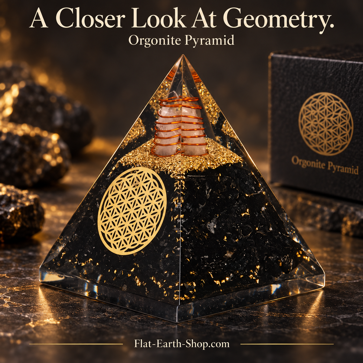 Close-up of a black and gold pyramid with a circular geometric emblem and coiled detail near the tip.