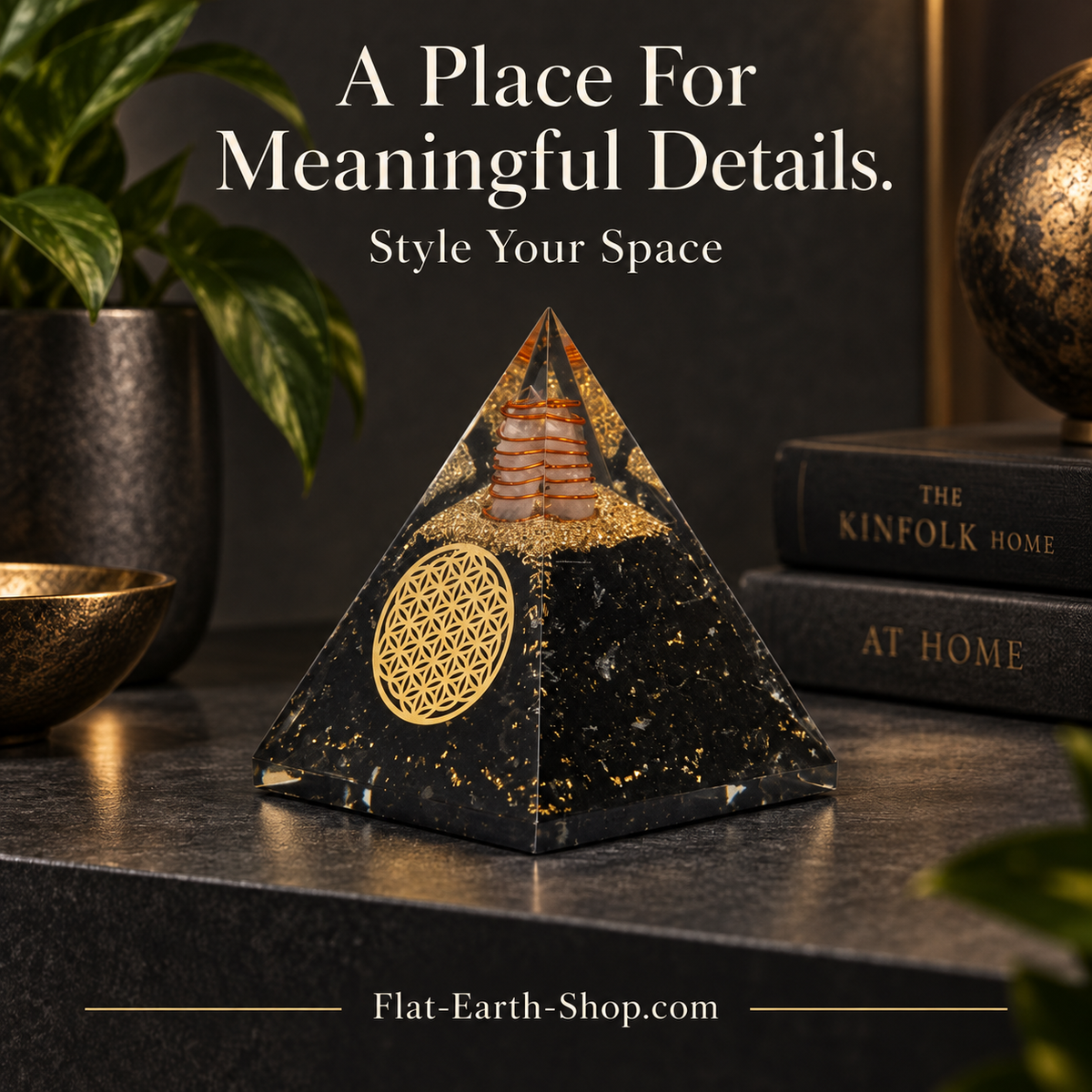 Black and gold pyramid displayed on a tabletop beside plants and stacked books.