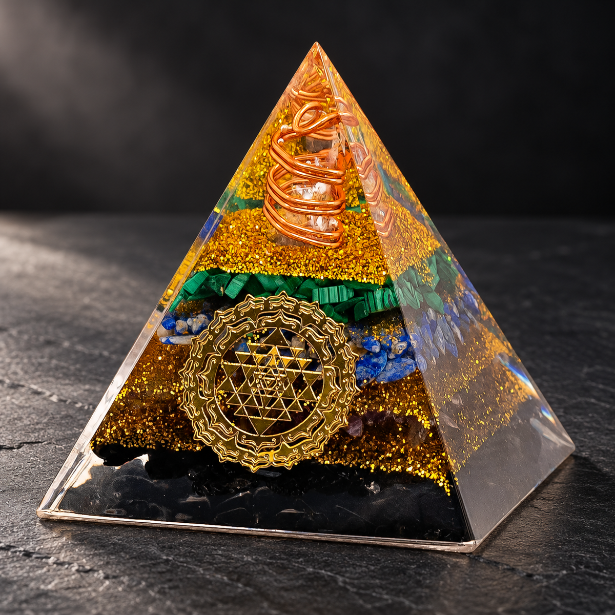 Tourmaline Orgonite Pyramid — Geometric Intention on a dark slate tabletop
