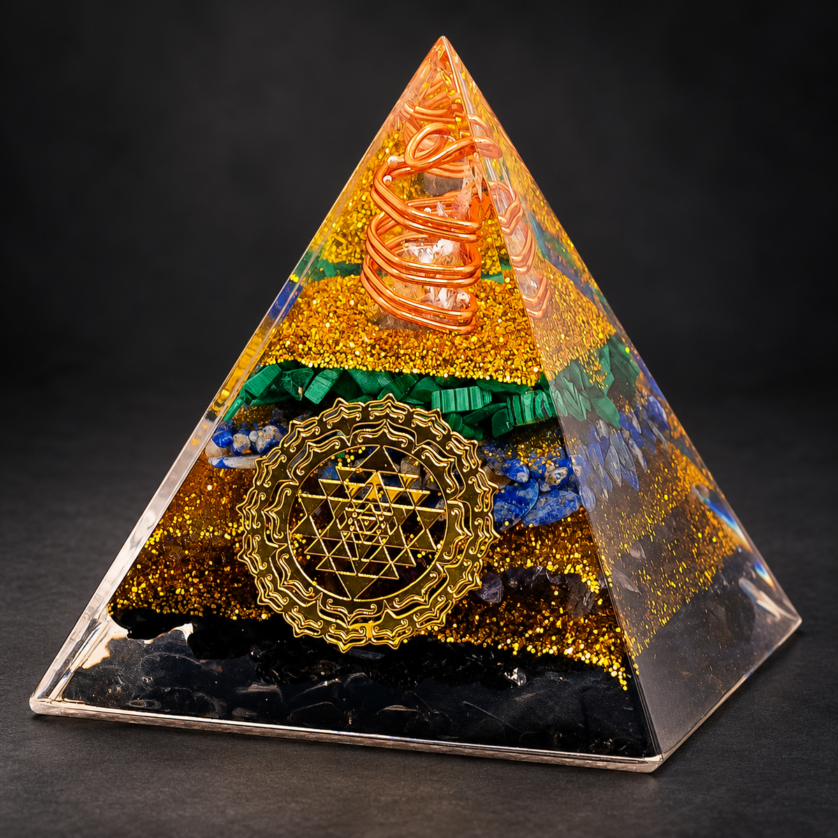 Tourmaline Orgonite Pyramid — Geometric Intention on a dark charcoal studio background