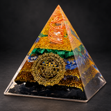 Tourmaline Orgonite Pyramid — Geometric Intention on a dark charcoal studio background