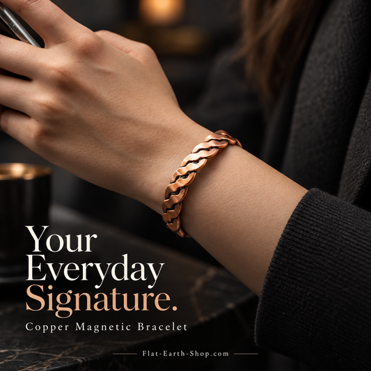 Twisted copper-colored cuff worn on a wrist beside a black sleeve.