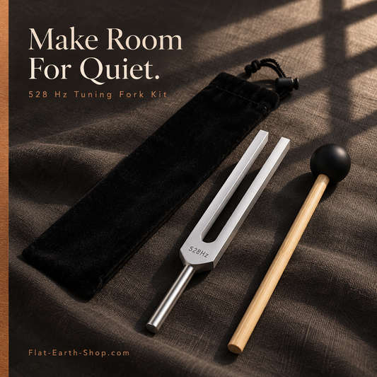 Silver-colored tuning fork marked 528 Hz, wooden-handled black mallet, and black drawstring pouch on dark fabric.